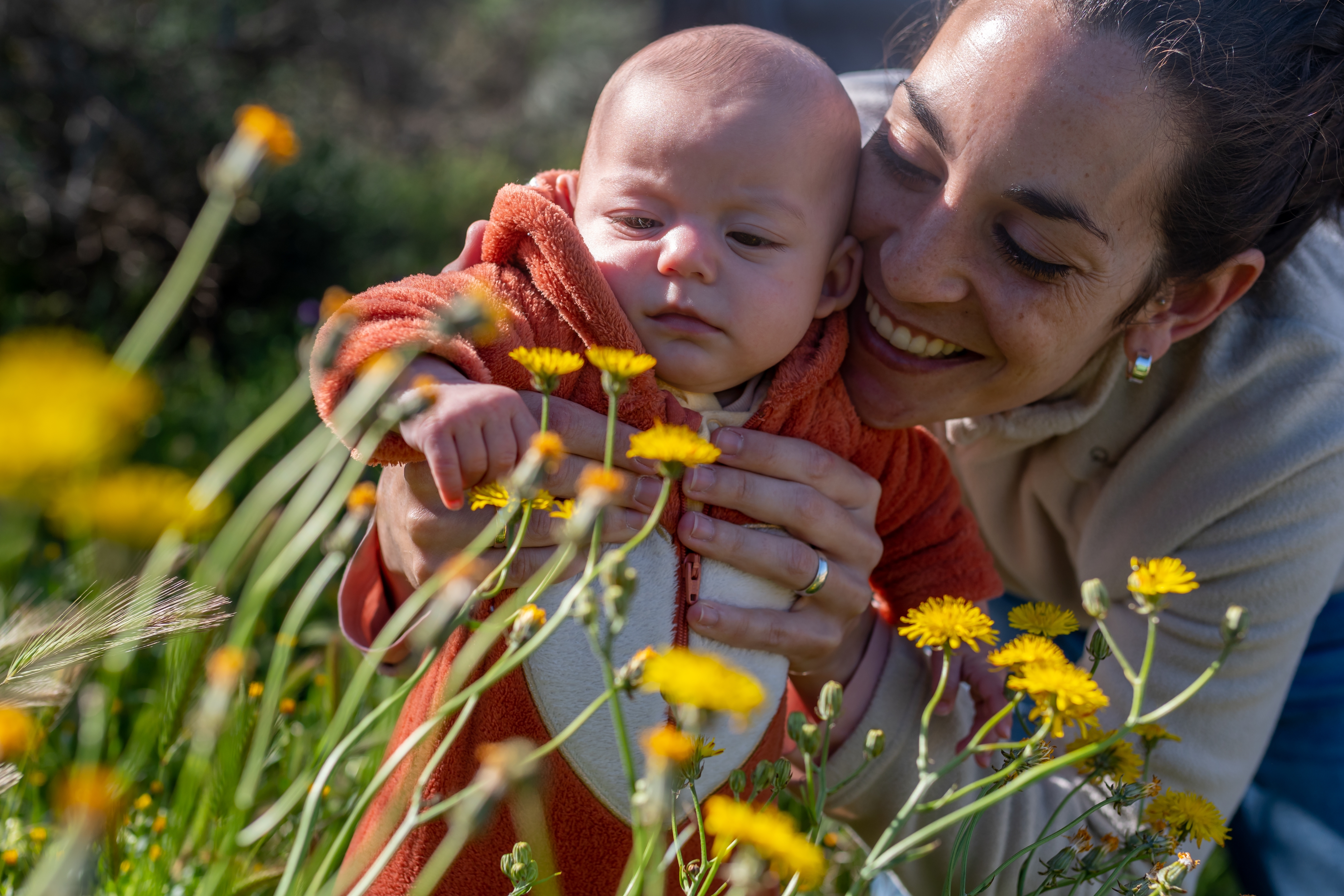 mom shows baby yellow flowers